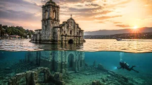 La iglesia de San Juan Bautista es el vestigio más emblemático del antiguo pueblo de Tequesquitengo, una comunidad que quedó parcialmente sumergida bajo las aguas del lago y cuya historia aún puede explorarse mediante recorridos turísticos y actividades de buceo./Foto: IA (copilot)
